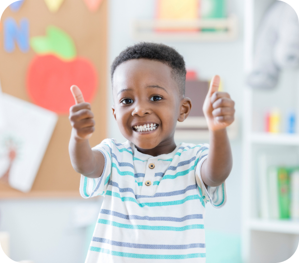 Kids smiling with two thumbs up