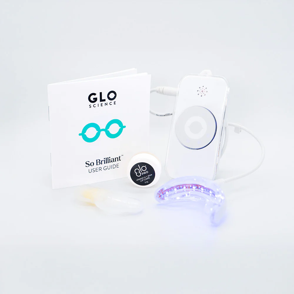 Pristine GLO Teeth Whitening kit with guide, gel, LED mouthpiece and more on a clean surface