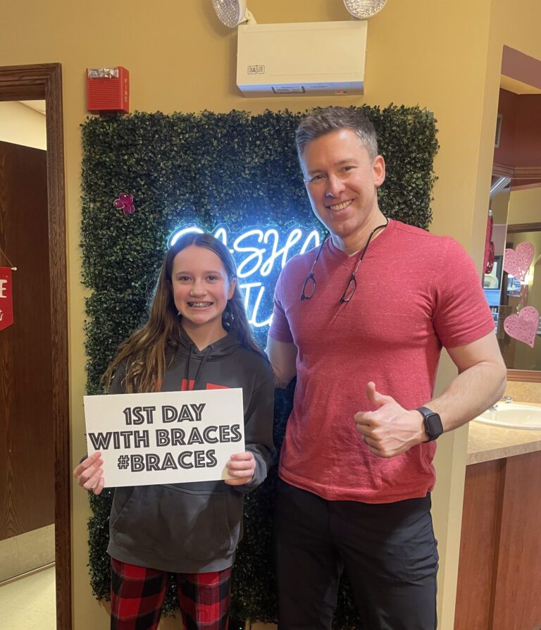 Dr. Wardell smiling with a teen patient after fitting her for braces